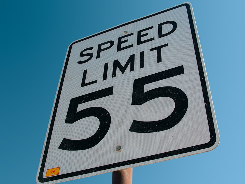 Traffic sign indicating a speed limit of 55 miles